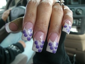 French tips using lechat powder gel as builder, and individual purple flower petals over white tips, and finish it with lechat gel top coat.