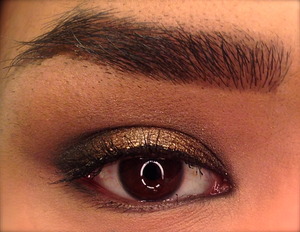 This is a black smoky eye topped with a bronze cream shadow. This look took quite a while as there was a lot of blending involved to achieve it. 

A tip: Putting a dark color down before a shimmery color will change it's finish. This cream shadow on its own is very orange, but on top of the black it looks very golden.