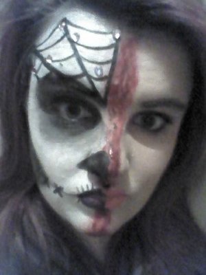 I would first like to point out that this is not at all any attempt at a sugar skull. Its basically half skull half normal.

white face paint is snazaroo and the black is eyeliner.

Rhinestones from ebay!