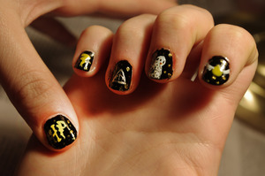 On a friend's nails.  From left to right: HP, a lightning bolt, the Deathly Hallows symbol, Hedwig, the golden Snitch
