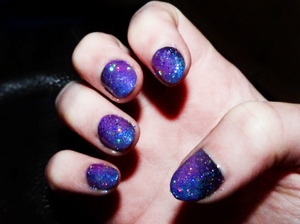 I sponged white, blue and pink over a black base, then added silver glitter over the top to give the effect of stars...