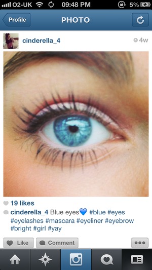 Pink cream eye shadow, black eye liner, blue eyes