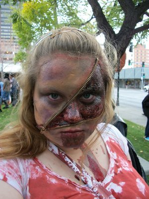 This is a photo of me during the 2010 Zombie Walk of Billings, MT. All I used was a zipper you get from a fabric store, or walmart, I cut the fabric part off of it, I then used bh cosmetic's pallets to create the bruises and then doused myself in fake blood! The bloody part of the zipper was some gel type stuff I got at Spirit Halloween and then I just added red pigment on top of it! 