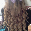 Curled hair with purple bow