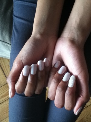 My cousins beautiful white shalac nails, one is covered in glitter (sorry if I spelt it wrong lool) 