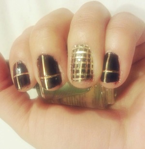 black nail polish with golden lines.