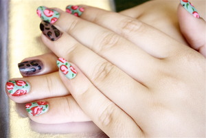 Simple vintage roses on my fingers with a dark leopard print accent nail on my ring finger. So easy even a caveman could do it! :)