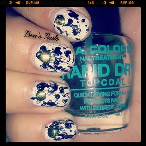 did a white base and splattered black polish. used a roud gold stud to accent the nails!