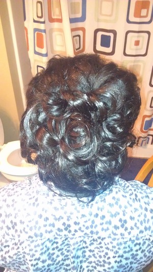 african american hair type. We started off by deep conditioning her hair. Then we clipped in 100% human hair extenstions. Curled it. Put into a loose ponytail. Then pinned up curls piece by piece. 