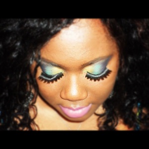 a make up look with yellow, green and purple eyeshadow and pink lips