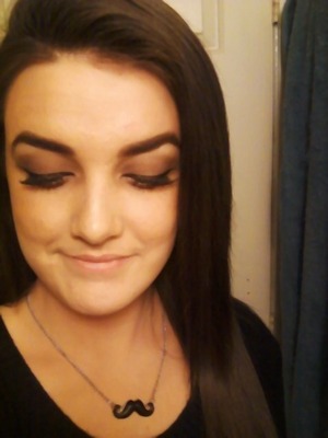 This is a really simple look and is also very easy.(:
First, I used my Covergirl foundation and a bit of a loose powder to set it. I then brushed through my eyebrows with an eyebrow brush and used a gel liner to line the outsides of my brows, then filled them in with a corresponding shadow. (Typically a color that matches your hair color). I used a brow gel after that to set the hairs, and keep them in place. I used a primer all over my eye lids and then used the dark brown eye shadow from the Clinique Colour Surge Quad. I covered my lid completely then added my highlight. (The lightest color tone in the Quad). I then used a a blending brush to blend the two colors together. After that, I used a gel eye liner to line my lids; giving a winged looked. I used my mascara to prep my lashes for my false lashes.I used 120 Demi Wispies. I apply them, then again to the roots of my lashes, apply more mascara. Giving the lashes more depth and holding them in place.I then take a white eye liner and line my lower water line. Using the same brown color that I used on my lids, I run that under my water line (bottom part of the eye) and blend it out. I go back with my mascara and cover my bottom lashes. Lastely, I use my bronzer and contour the sides of my face, in my cheek bones and up the sides of my face in the temple. Then also down my neck. Nobody wants a bronzed face and an off colored neck. (:
Lastly you can add a nude colored lipstick or any lip product of your choice. I'm just wearing good old Chapstick. (: Xoxx Then your done!
