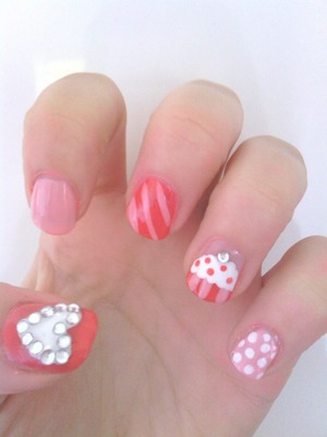 A mixture of different nail art designs, rhinestone heart, stripes, polka dot and cupcake