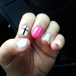 Gel nail polish with glitter and a cross  