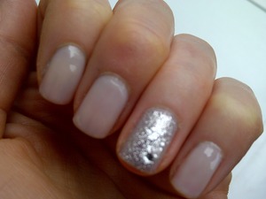 A neautral nail look with a splash of diamonds on the ring finger