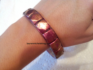 I used nail polish to transform a tarnished bracelet. 
http://laurenmicheleblog.com/2012/09/22/diy-autumn-leaves-jewelery/