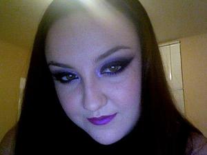 my new years eve makeup :). smokey cat eye with glitter on the eyes and the lips. rocking bright purple lips because i can haha. sorry the quality is so bad. i took it quickly on my macbook. :P