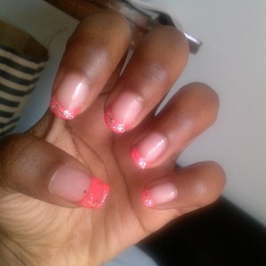 pink nail tips with silver glitter polish on top. (natural nails)