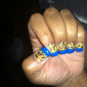short and sweet cheeta nails with a gold strip to accent the royal blue...