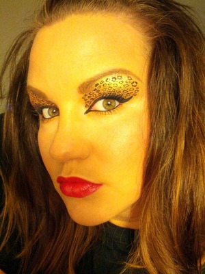 leopard eyes is actually easy to do but it requires patience. 
1. apply eye shadow primer on both lids. 
2. apply bright iridescent gold shadow from lid to brow. I used Kat Von d's in devotion. 
3. in the crease I used Yves saint laurents quad #8 medium brown.
4.  in outer corner I used dark brown in Yves saint Laurent.
5. then using Chanel liquid liner I applied small circles and dots all over lid. then applied along my lid to inner and outer corner. 
6. black eyeliner on waterline. 
7. Chanel volume mascara
8. chanel rouge coco lipstick in shade Gabrielle. 
that's it! 