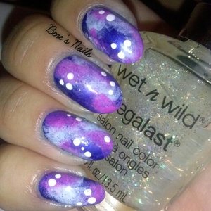 A dark blue base with pink, baby blue and purple sponged on in random places to create clusters and nebulas. Dotted white dots for stars and finished the look with a fine silver glitter and matte top coat.