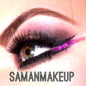 A fierce smokey eye with a pop of purple glitter in between the double-winged liner!