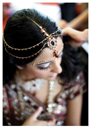 Tikkah , jewels, fake lashes, pink+ purple eyeshadow, liner and pink blush. Loose curls in a half updo