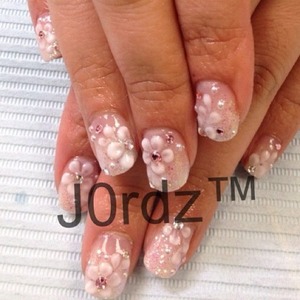 Clear glitter base over white color gel faded

3D flowers made and sculpted with EzFlow truly white powder and monomer.

Swarovski clear and light pink rhinestones – sizes ss9 ss7
http://fingertipfancy.com/3d-white-on-white