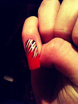 hand paited flicks, simple.
Red polish, Rio nail pens in White, Black & Gold used to create 'stripes/flicks'