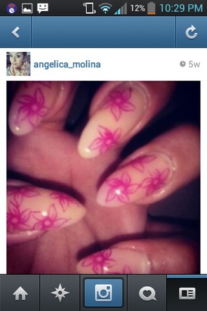 Cute nude stiletto nails with rasberry pink flower stamps