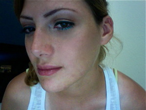 light brown smokey eye with green eyeliner and teal eyeshadow under the eyes. 