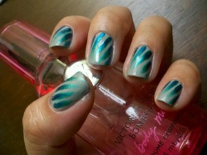 Wisps of blue and teal made with OPI Swimsuit...Nailed It! and NOPI Iceberg Lotus on a gray background. 