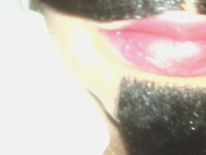 Pink lipstick with orange dabbed in center. The facial hair isn't real. Really.