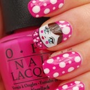 Hot pink polka dot nails with doll accent nail.