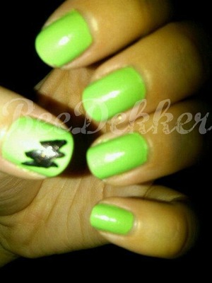 simple statement nails using a lime green polish and adding a black lightning bolt to the thumb.
