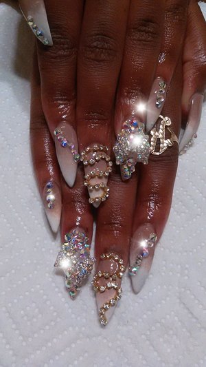 Beautiful ombre stiletto nails dripped in swarovski crystals