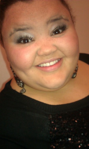 Fake lashes with a light smokey eye , up do for the ear rings , black sparkly shirt , and to pull it all together .... A smile (: # like