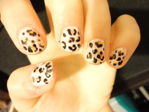 Skin tone base, gold spots, and black outlines to make a well put together cheetah nails look :)