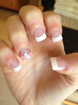 Acrylic nails with pink and silver polish and diamond. 