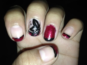 Red and black tips with a flower on my middle finger and on my ring finger I put a black tip on top of the red.