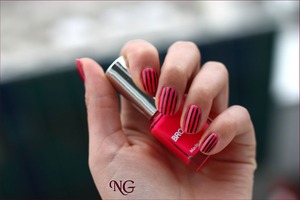 Neon pink nails with black stripes