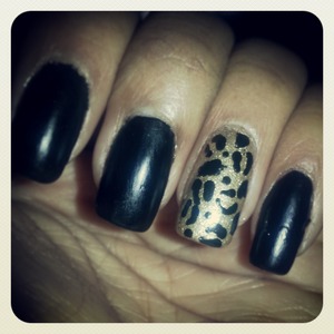 Matte black nails and gold leopard accent nail