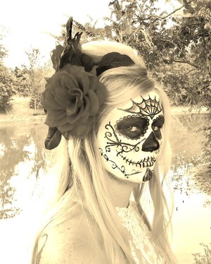 This is a sugar skull that I did on a friend. Honestly it was my first time ever to do this and I was just practicing. But it turned out pretty neat. I also made the flower and did the hair. Picture was taken by me as well. The products used were things around the house and cheap halloween makeup which I dont recm. because it cracks and isnt very good. But again it was just for practice.