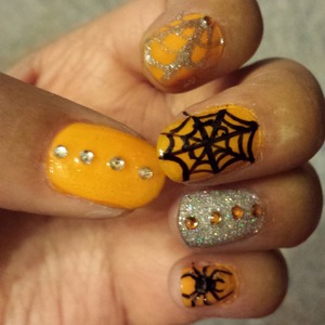 orange nails with spiderwebs and spiders