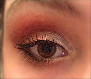 One of my favorite looks. Used a dark brown in the outer corner, and focused on bronzes in the middle and up toward my brow. Used a white shadow for a base and kept it white in the inner corner and as a brow highlight. For the bottom, I used some of the brown shadow from the outer corner. Lined with a bronze liquid eyeliner, and then layered a black over and created a thin wing. :)