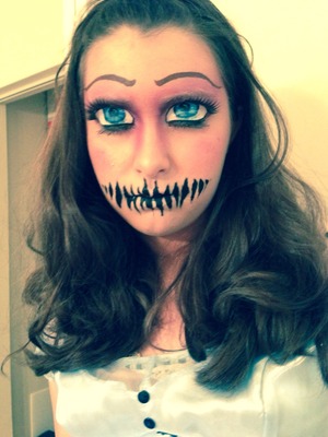 Blocked brows, airbrush face, and face painting. Her eyes are closed 