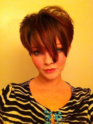 Short edgy hairstyle w/ tips of pink
