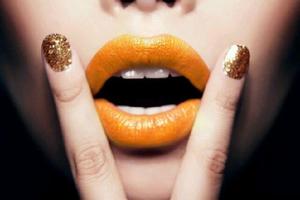 I used Cinema Secrets Ultimate Eyeshadow in Apricot and mixed it with clear  Maybelline Lip Gloss to get this color. I applied it with with a Makeup Forever Lip Brush. I used the same lip gloss on the models nails and then sprinkled over Glitter Pailettes Purpurina in shade Carmel, purchased at Michael's craft store. 