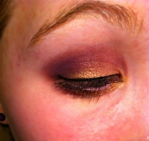 A purple and gold eye, with black liquid liner.