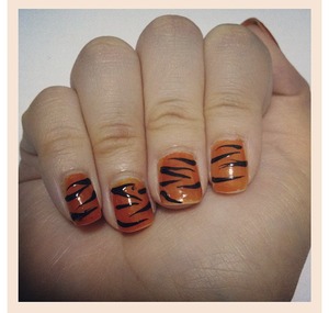 I was trying out tiger stripes nail art and I like this design. I have a video on how I did it (: 
