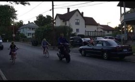 Daddy pulling Briella's bike with a scooter